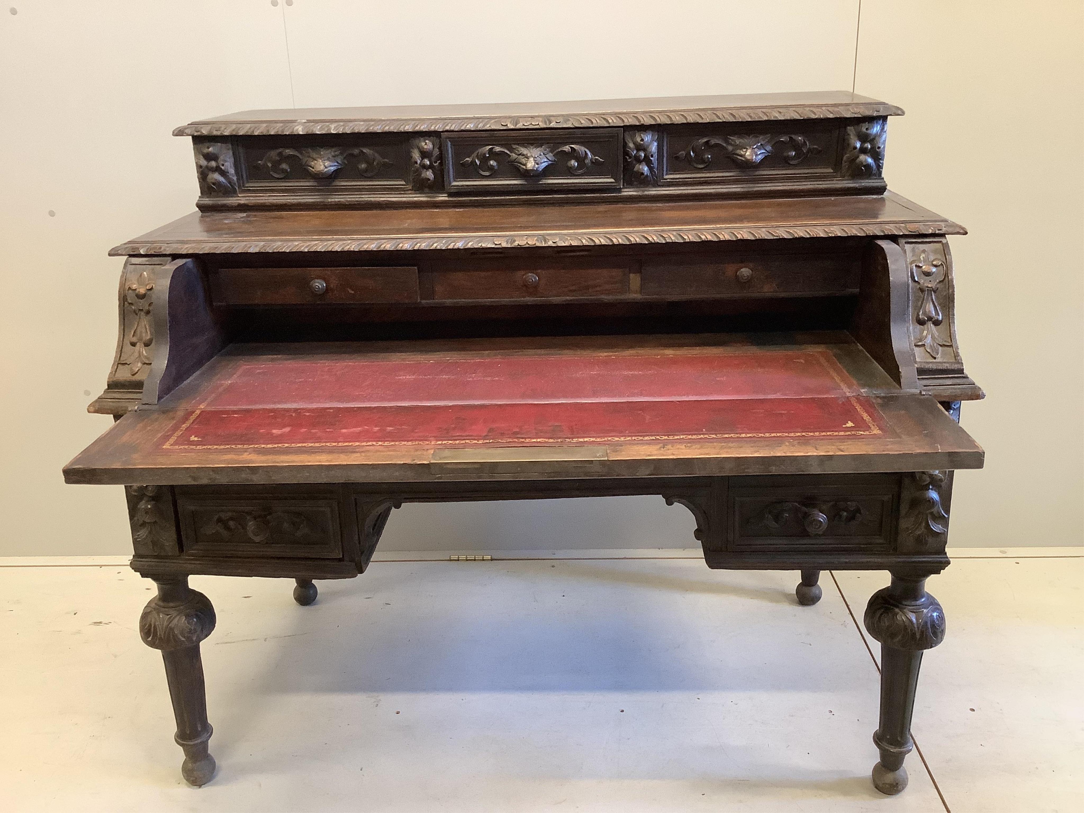 A late 19th century Flemish carved oak secretaire kneehole desk, width 129cm, depth 71cm, height 111cm. Condition - fair